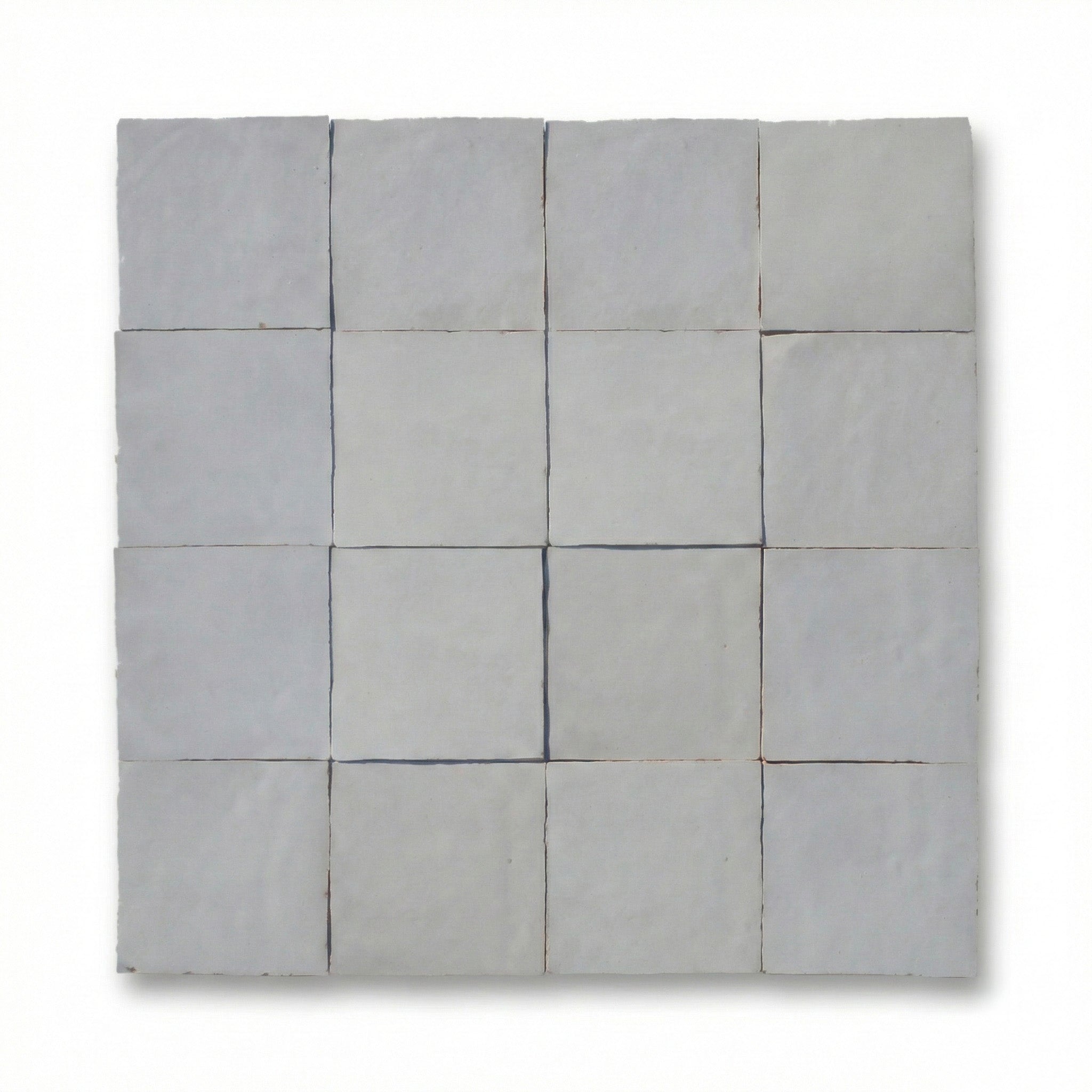 Gray quilt with a patchwork pattern on a white background
