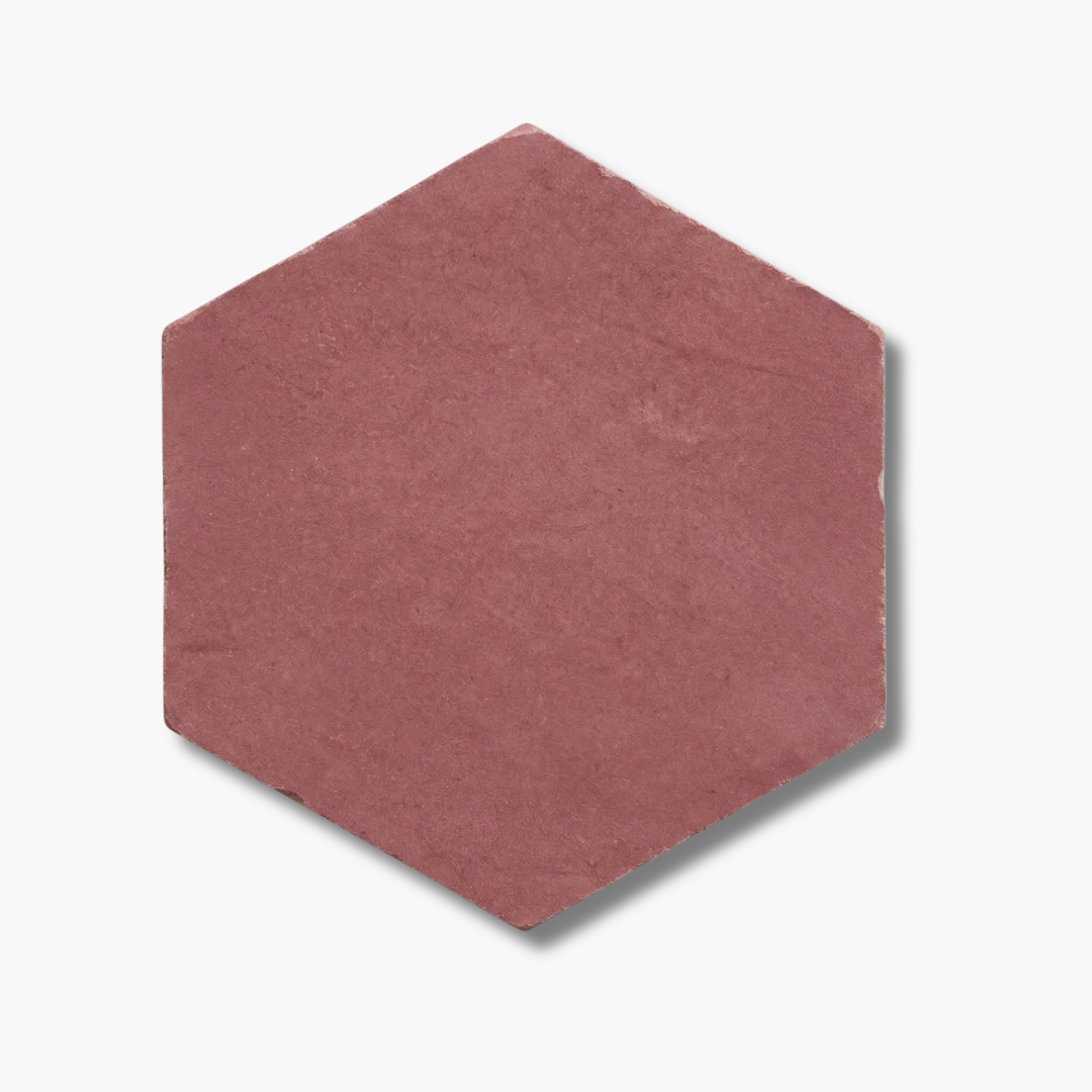 Hexagonal pink tile with a reddish-brown color on a white background