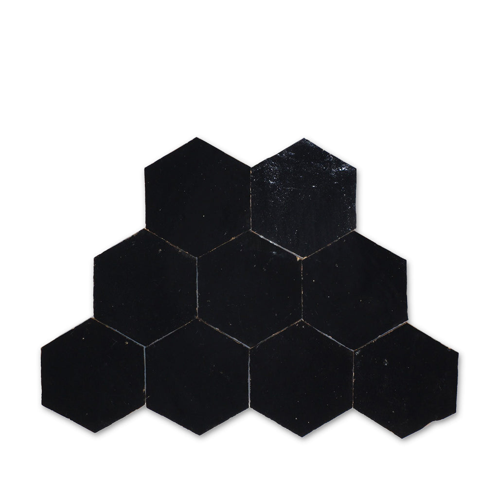 Hexagonal black tiles arranged in a pattern on a white background