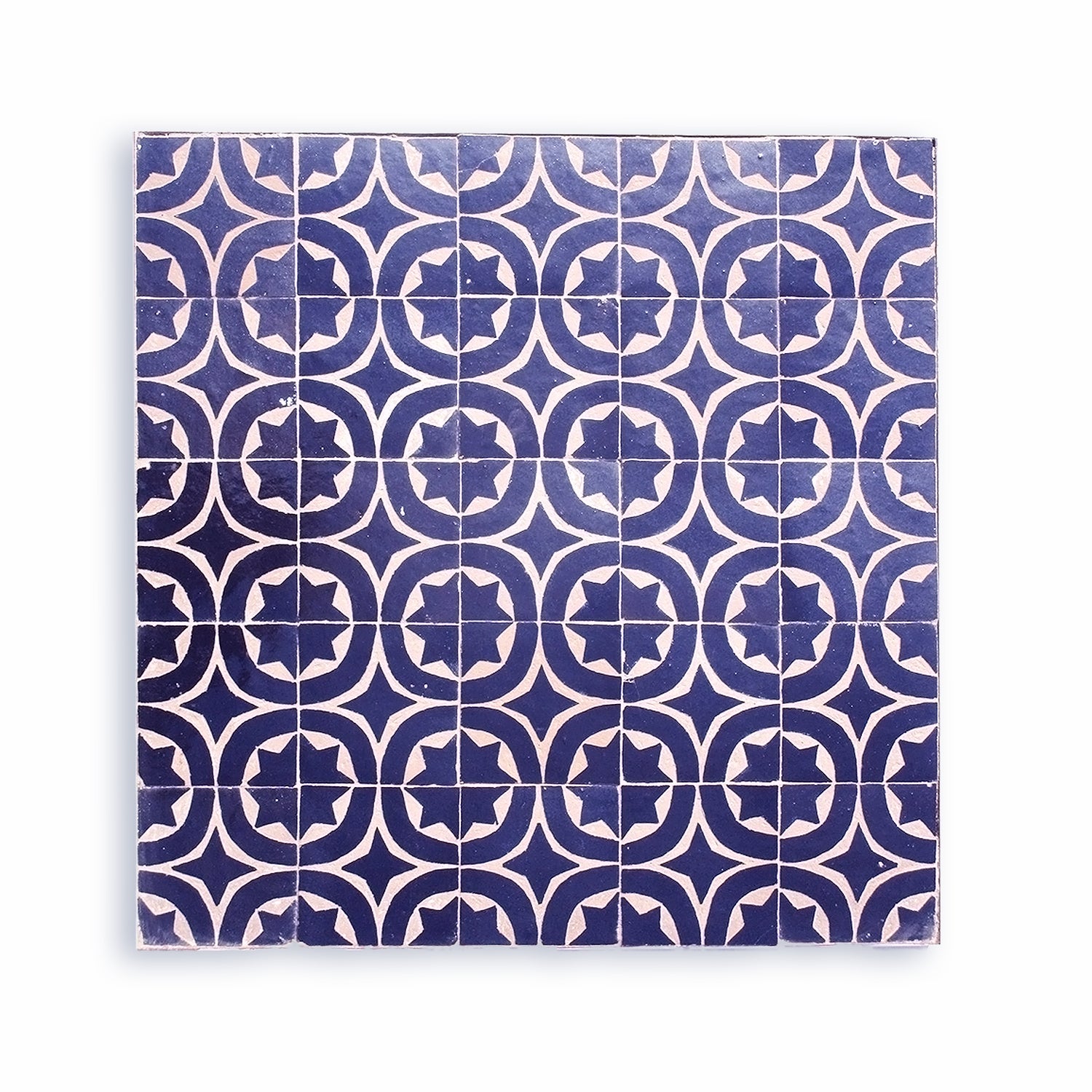 A handcrafted Moroccan zellige tile with a vibrant cobalt blue glaze. The intricate star and circle pattern is hand-chiseled by Tétouan artisans to reveal the natural clay.