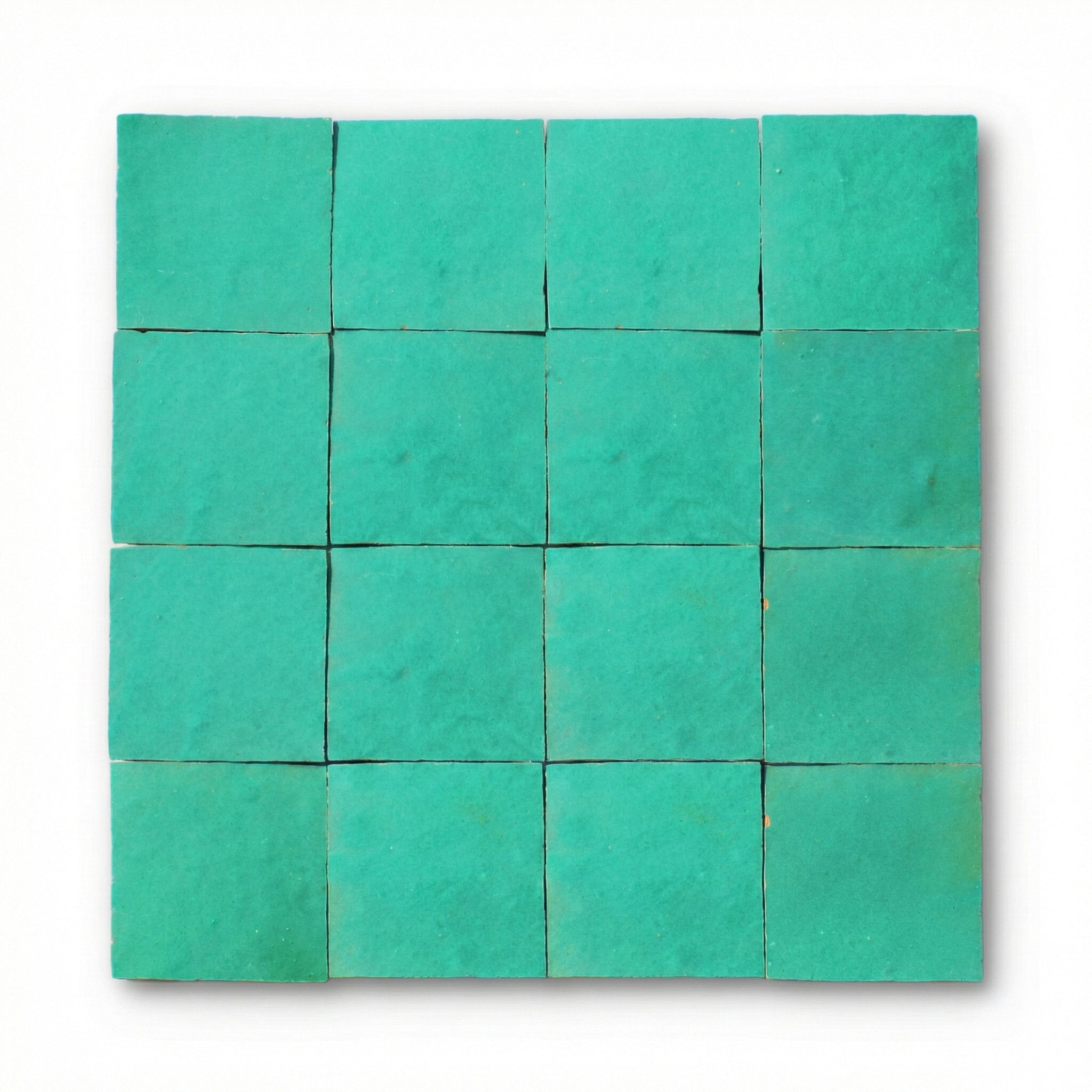 Ouarzazate Green Zellige tiles, 10x10cm handcrafted Moroccan emerald green terracotta wall tiles with a glossy, textured finish.