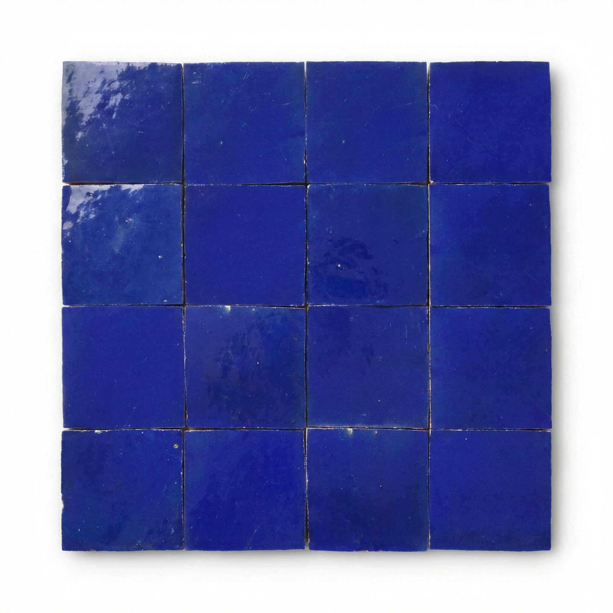 Tanger Dark Blue Zellige tiles, 10x10cm handcrafted Moroccan navy terracotta wall tiles with a glossy, reflective finish.